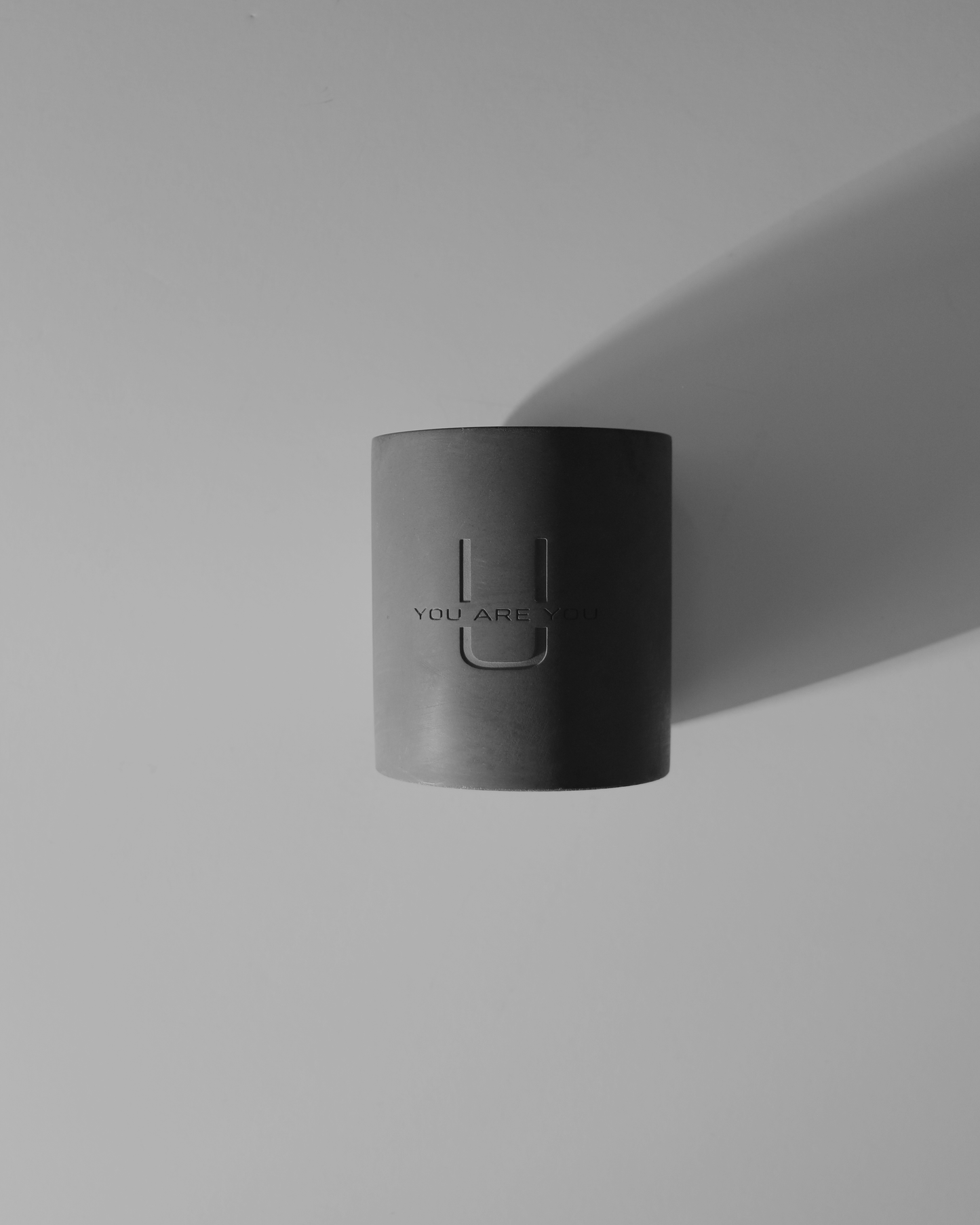 High-end scented candle adding warmth and elegance to a minimalist home decor setting.