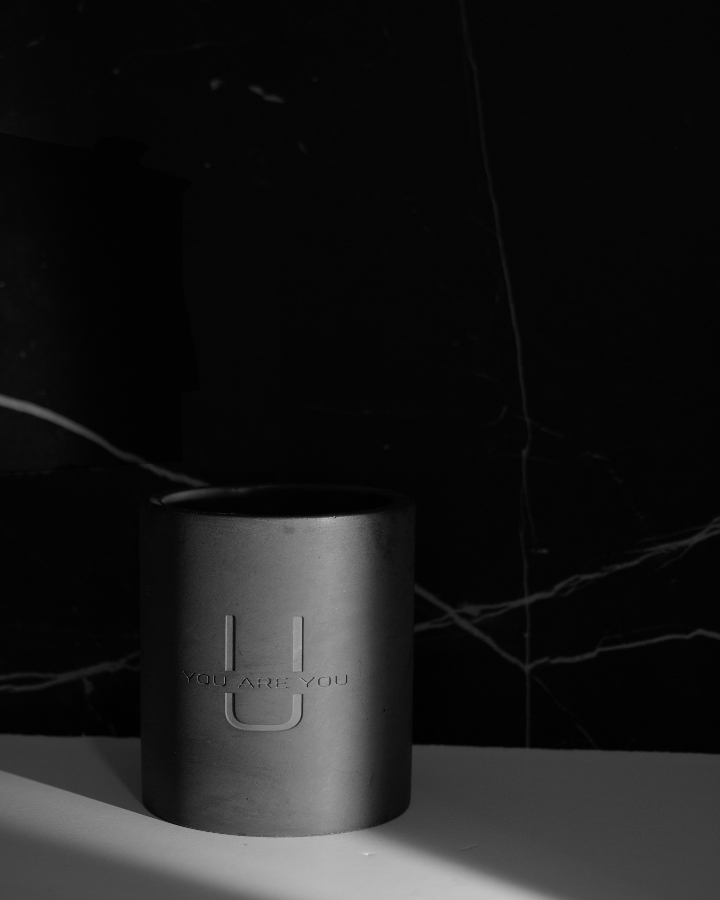 Minimalist candle in black cement jar